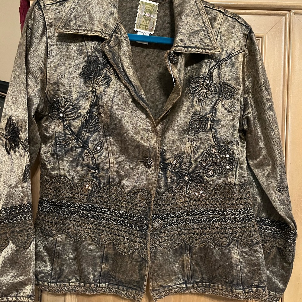 Leather jacket faux. Won’t see this style jacket anywhere.  Bronze and Black.